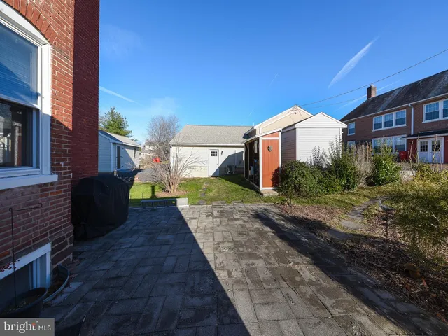 a view of a house with a yard and sitting area