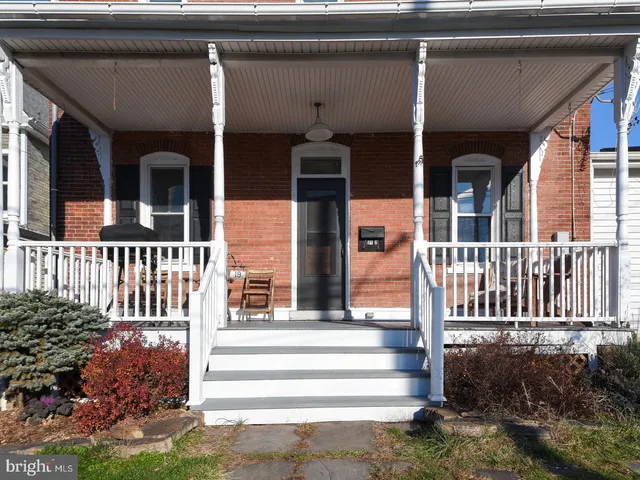 a front view of a house with a porch