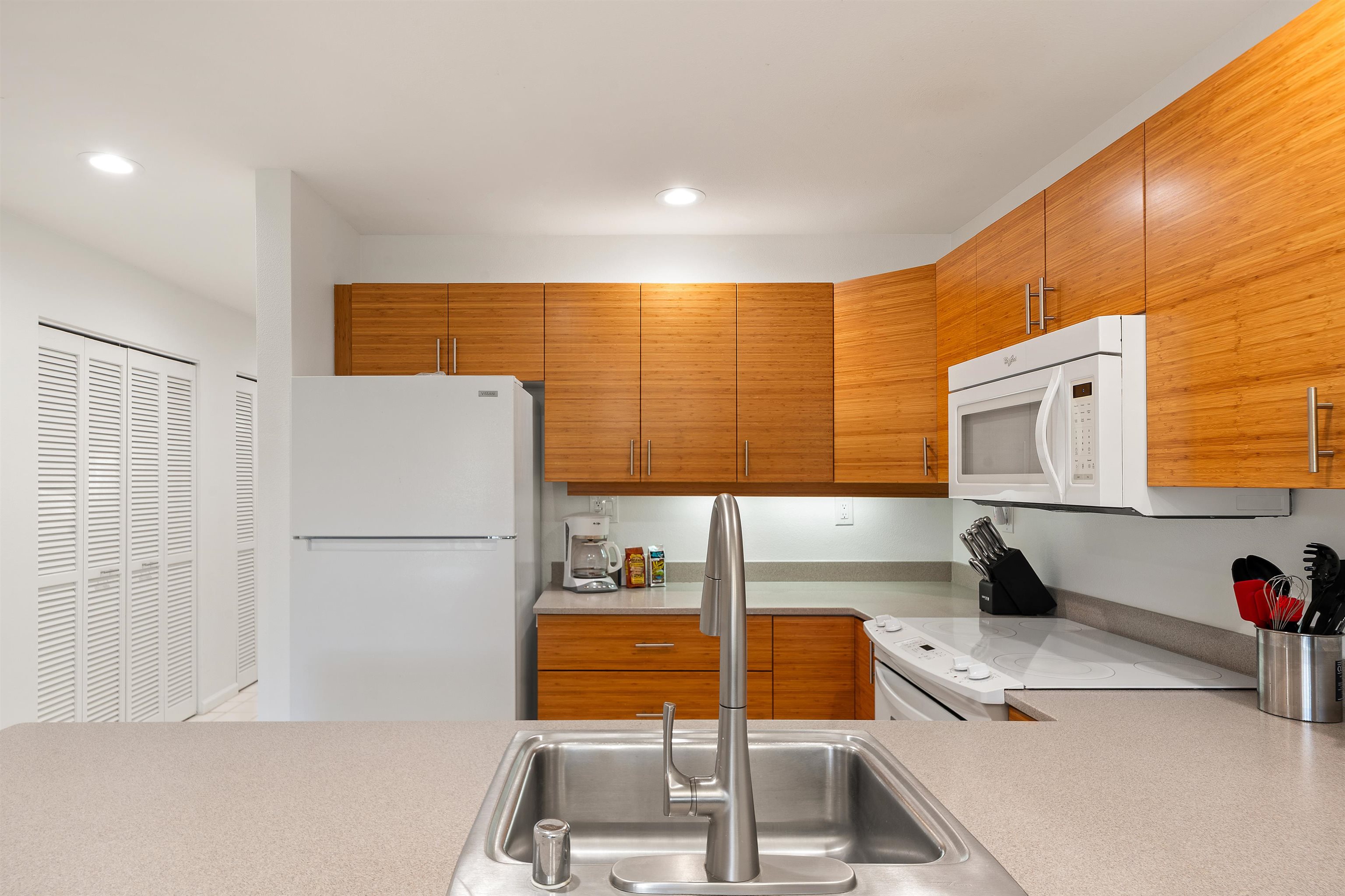 2777 South Kihei Road, Unit K102 Kihei, HI 96753 - Photo 14 of 41 a kitchen with a refrigerator and a sink