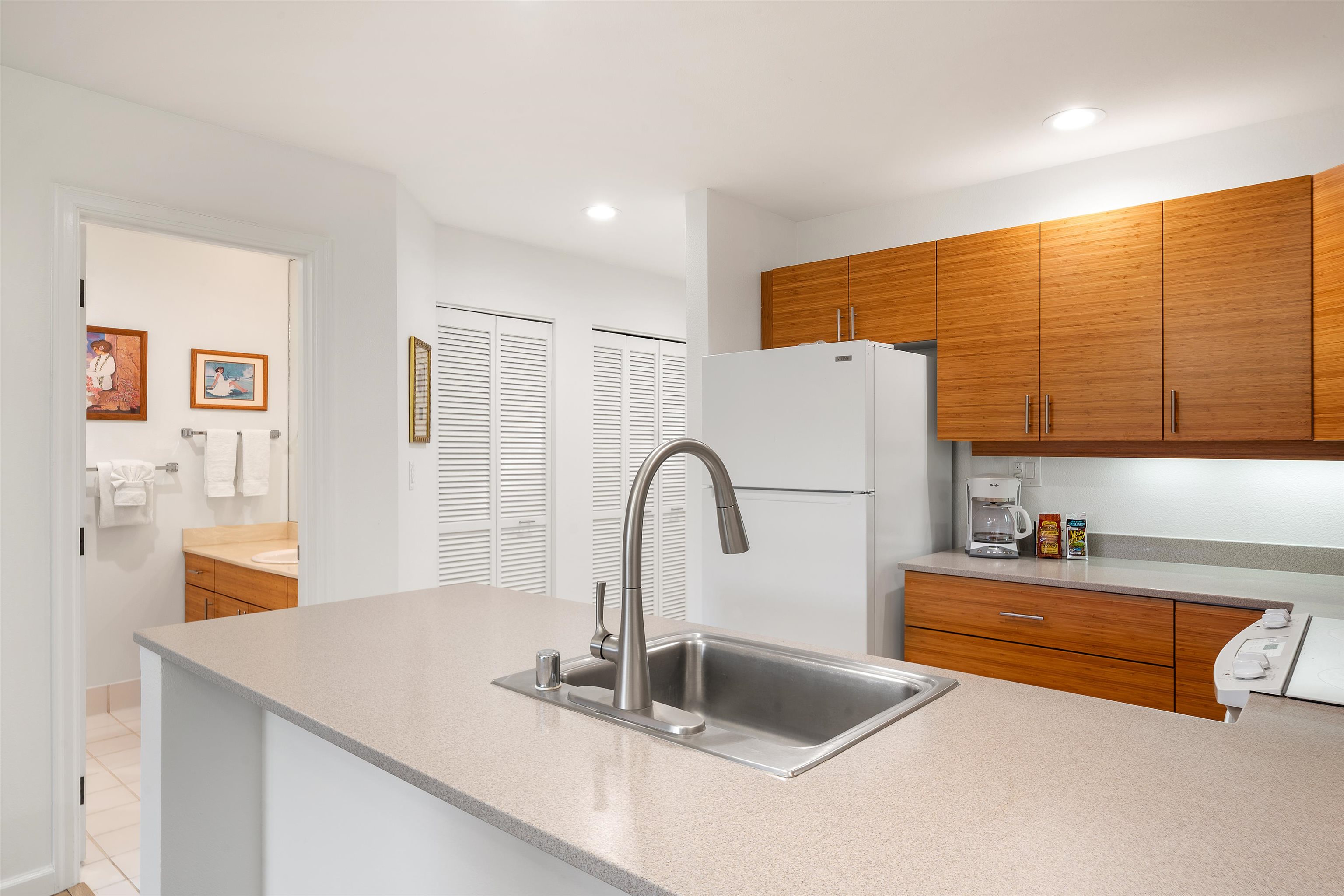 2777 South Kihei Road, Unit K102 Kihei, HI 96753 - Photo 20 of 47 a kitchen with sink a faucet and chairs