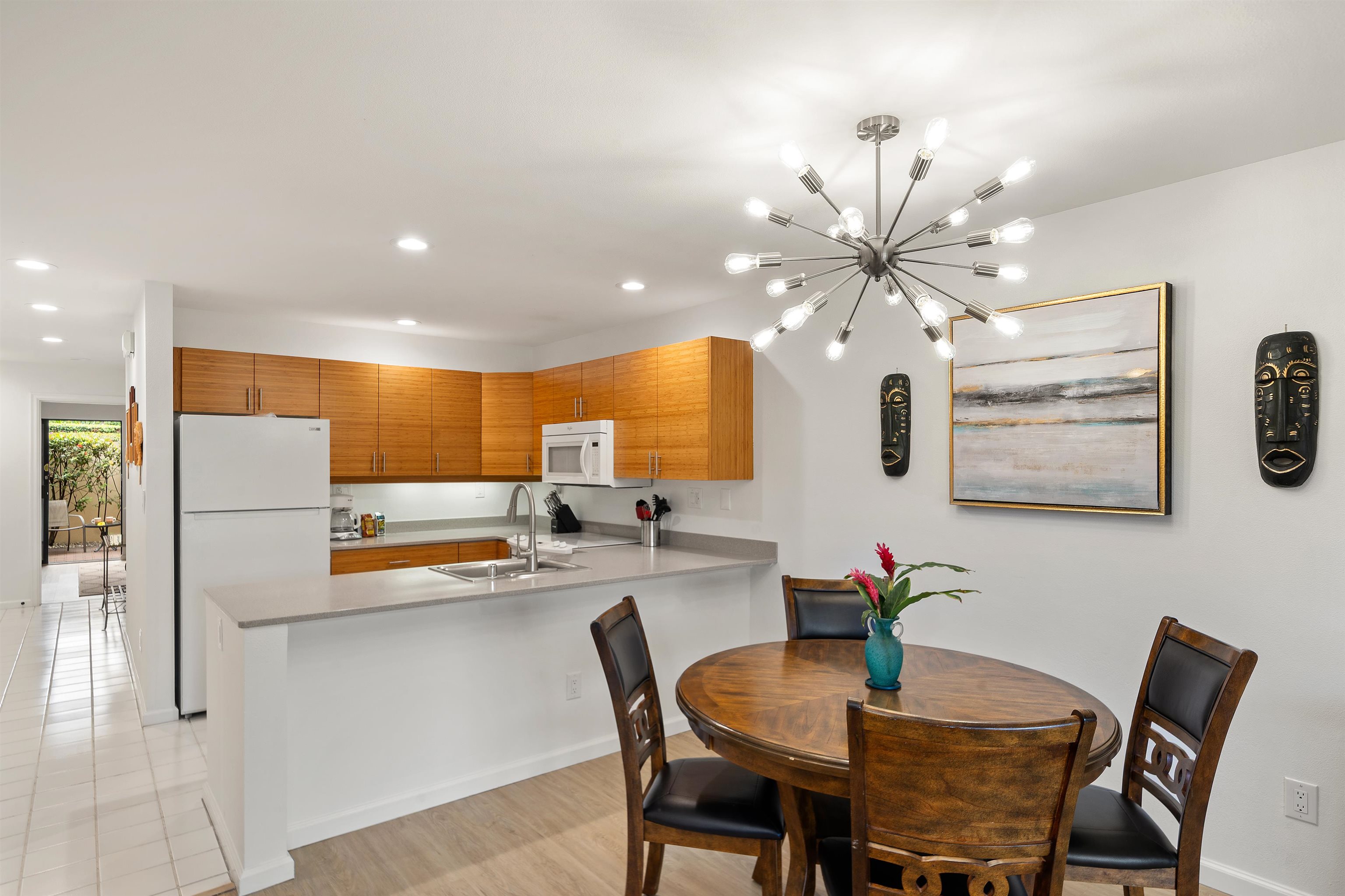 2777 South Kihei Road, Unit K102 Kihei, HI 96753 - Photo 21 of 47 a view of a dining room with furniture and a chandelier