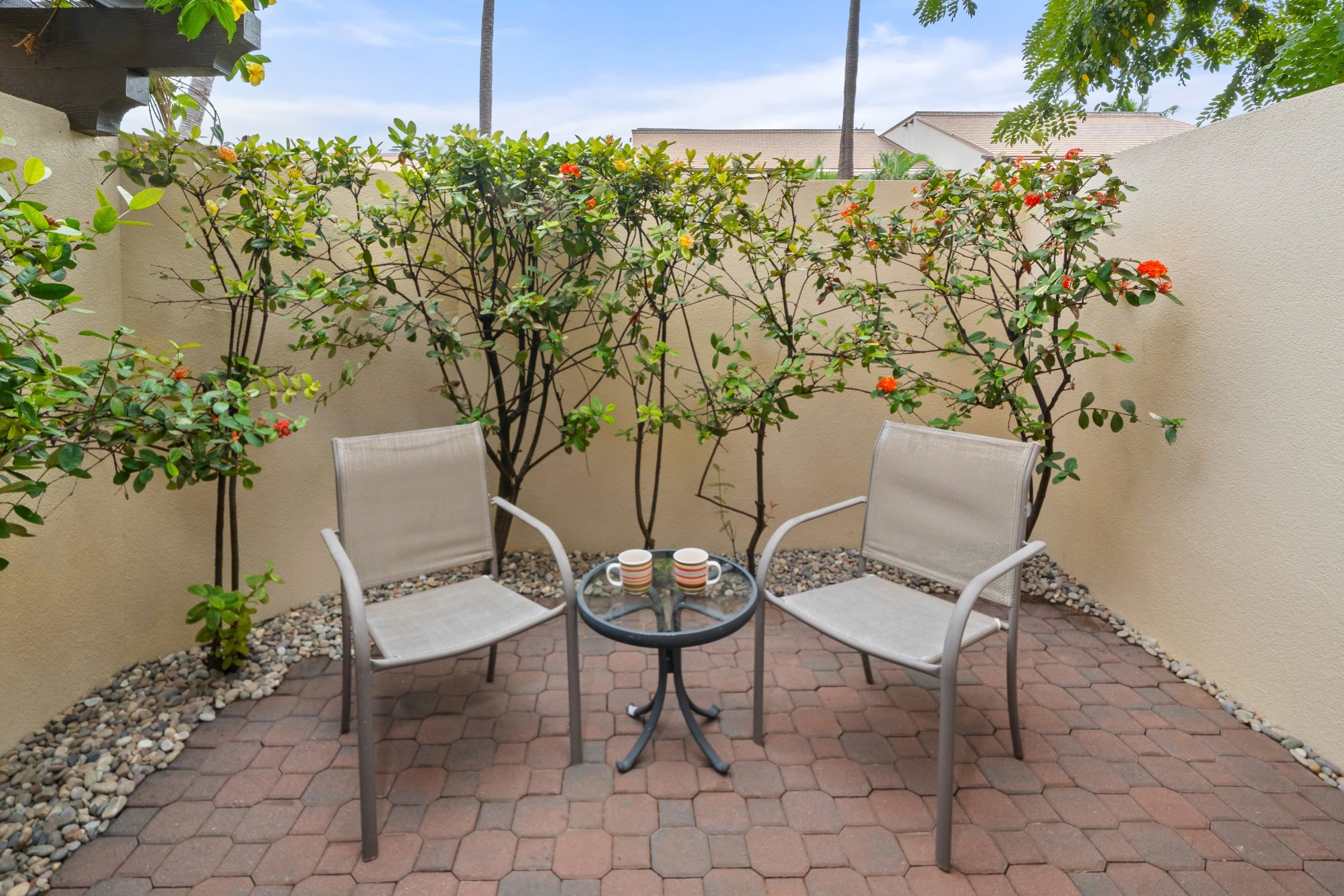 2777 South Kihei Road, Unit K102 Kihei, HI 96753 - Photo 23 of 41 a view of a chairs and table in backyard