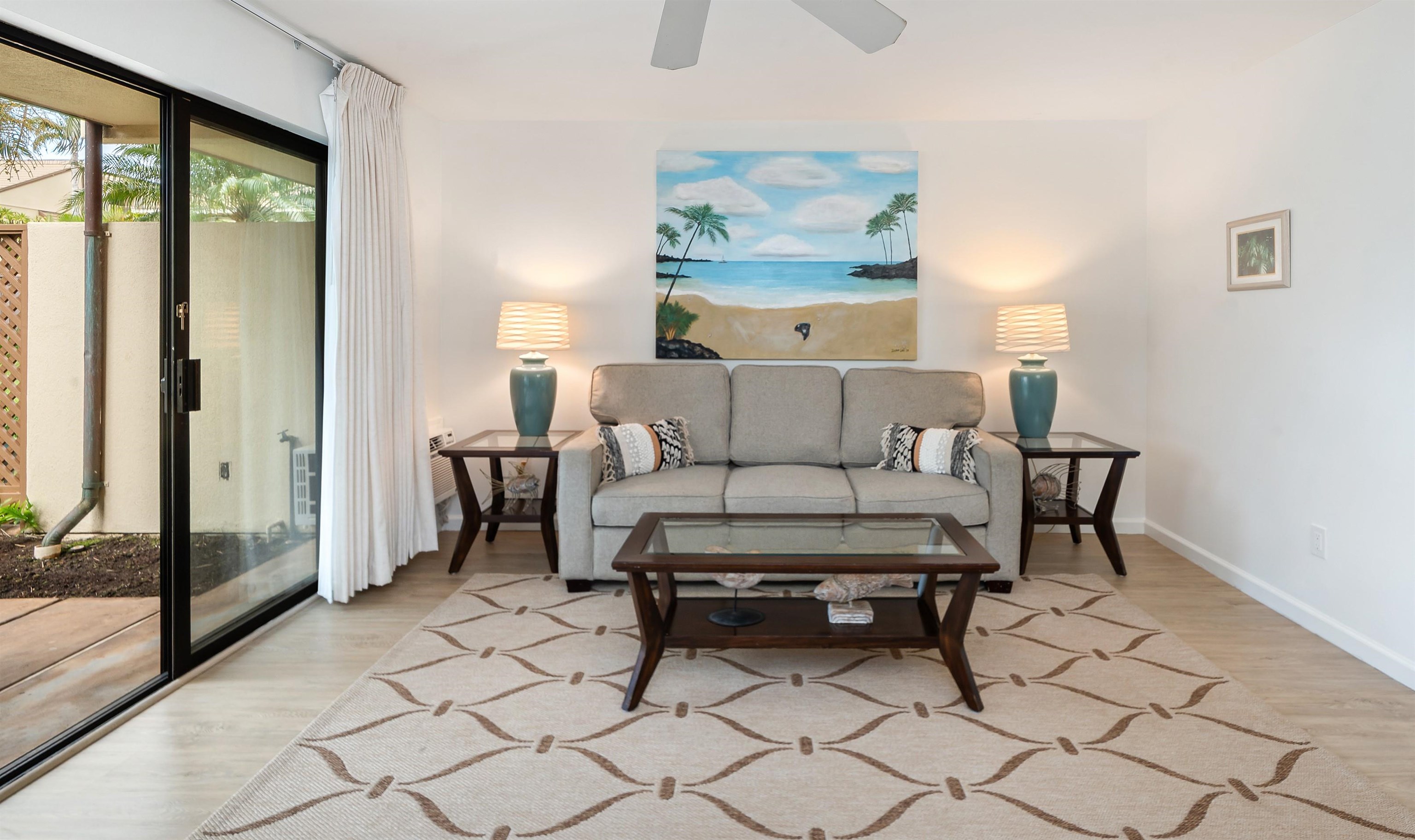 2777 South Kihei Road, Unit K102 Kihei, HI 96753 - Photo 25 of 47 a living room with furniture and a painting on the wall
