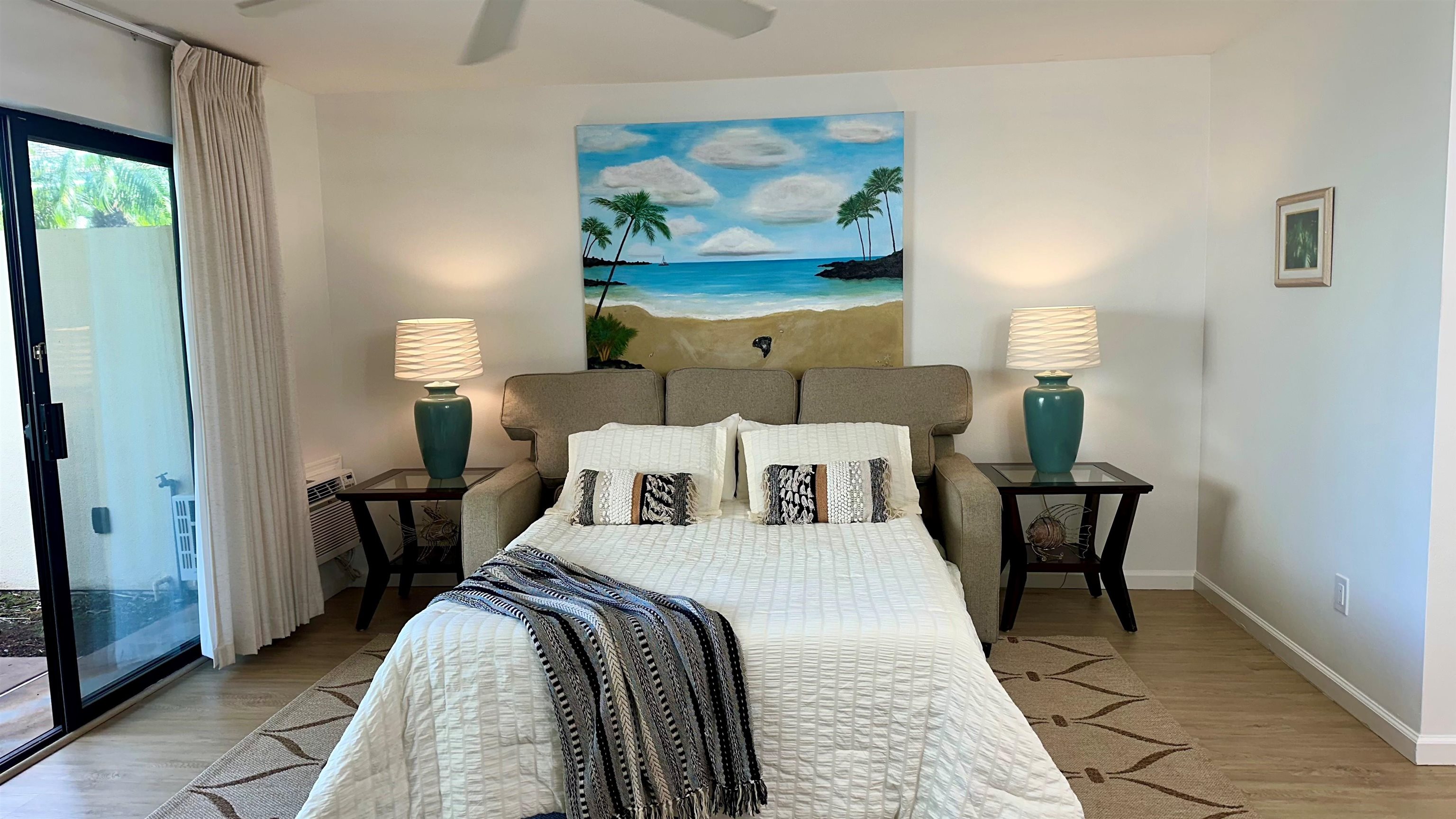 2777 South Kihei Road, Unit K102 Kihei, HI 96753 - Photo 26 of 47 a bed room with a bed and a painting on the wall