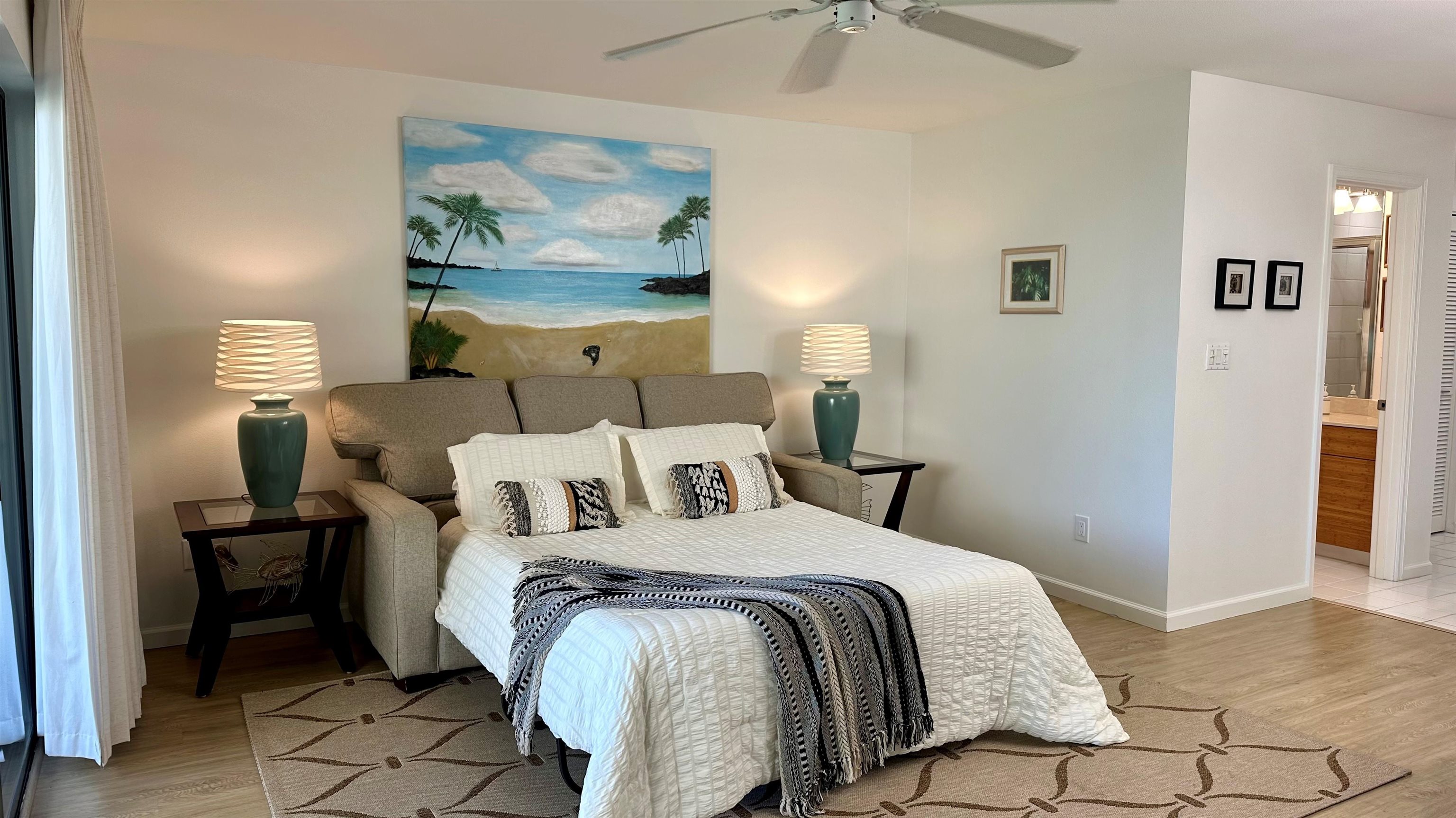 2777 South Kihei Road, Unit K102 Kihei, HI 96753 - Photo 27 of 47 a bed room with a bed and a painting on the wall
