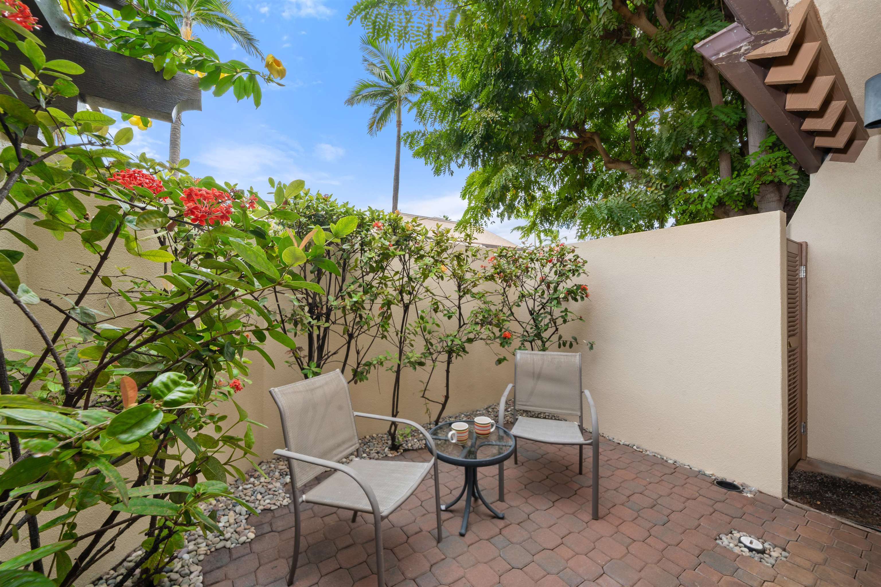 2777 South Kihei Road, Unit K102 Kihei, HI 96753 - Photo 30 of 47 a view of a chairs and table in a backyard