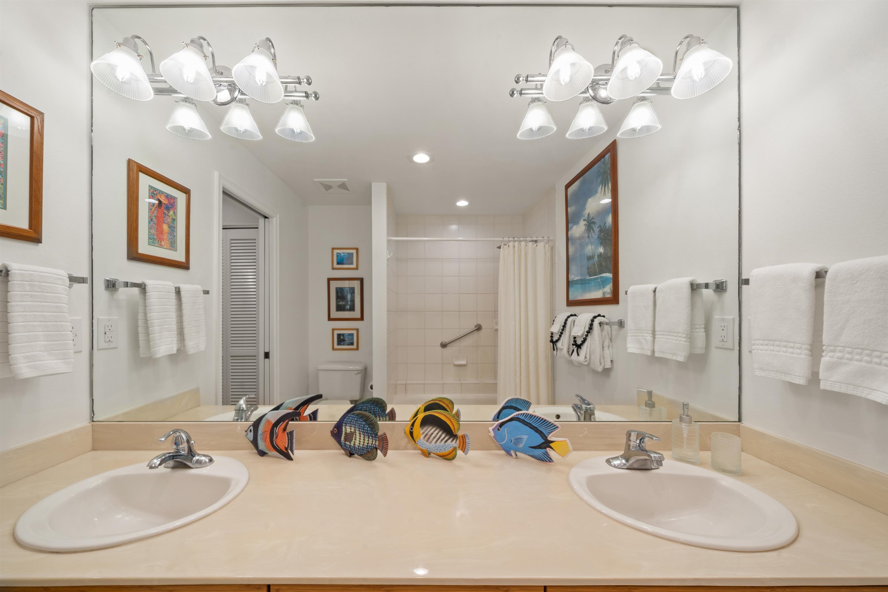 2777 South Kihei Road, Unit K102 Kihei, HI 96753 - Photo 34 of 47 a bathroom with a sink a mirror and a chandelier