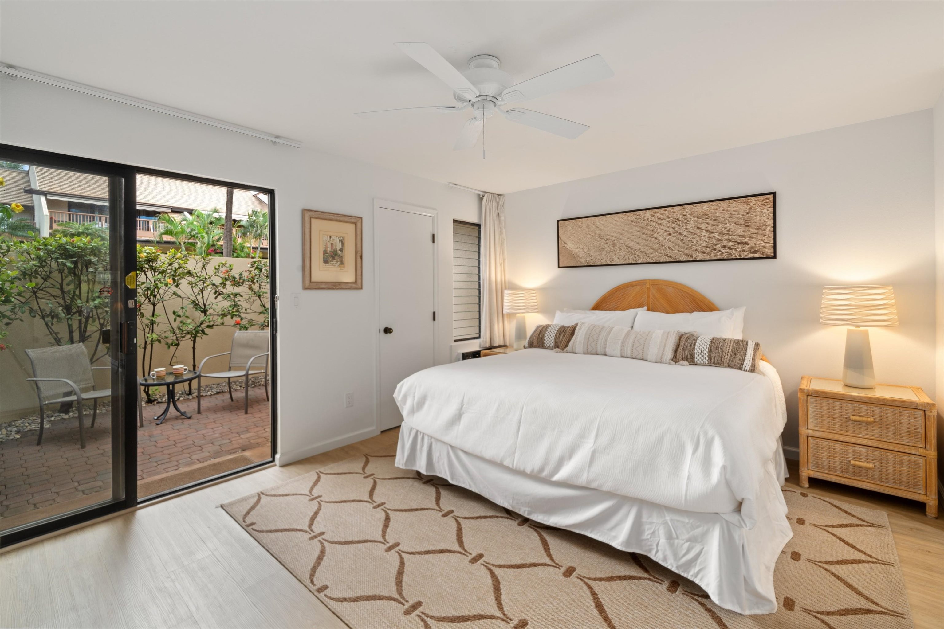 2777 South Kihei Road, Unit K102 Kihei, HI 96753 - Photo 5 of 41 a bedroom with a bed and glass door