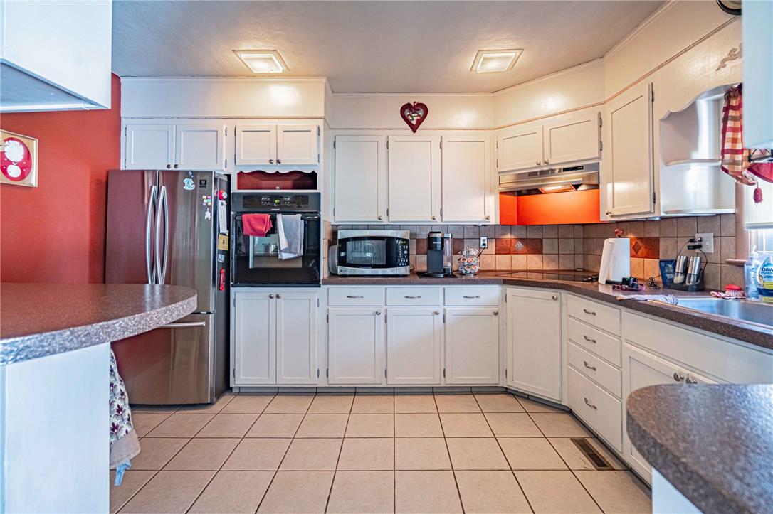 579 Cherry Road Northampton, PA 18067 - Photo 17 of 57 A well-appointed kitchen features ample white cabinetry, integrated appliances, and a convenient breakfast bar.