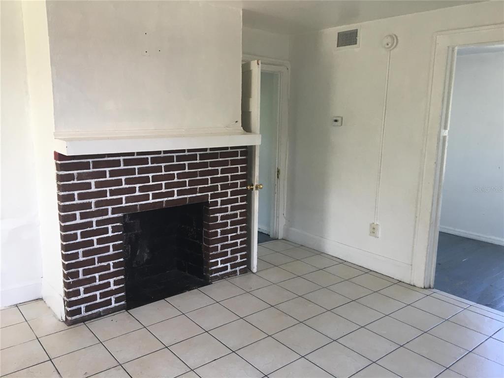 124 Daytona Avenue, Unit 2 Holly Hill, FL 32117 - Photo 4 of 6 a view of an empty room and fire place