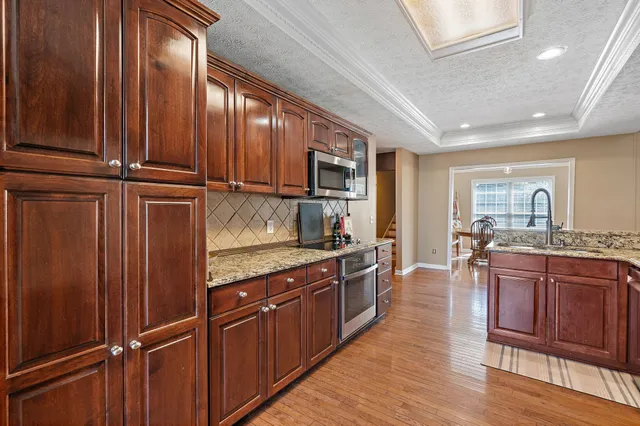 a kitchen with a refrigerator a stove a sink and a window