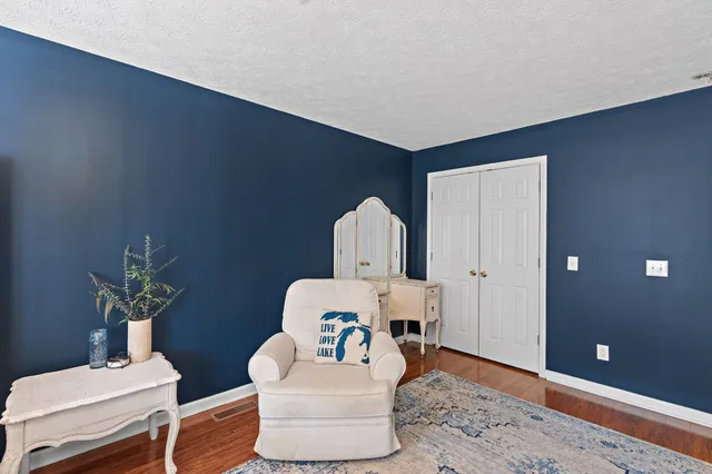 a view of house with yard and sitting area