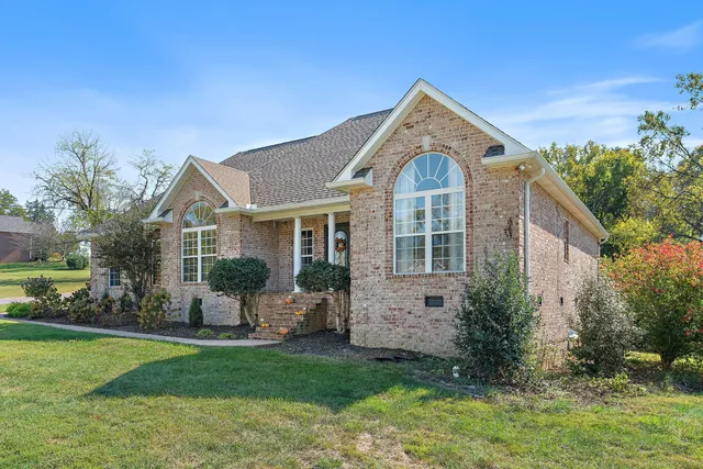 a front view of house with yard and green space