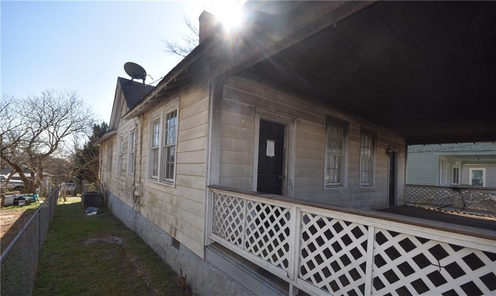 68 Poplar Street Porterdale, GA 30014 - Photo 3 of 13 a view of a house with a wooden fence