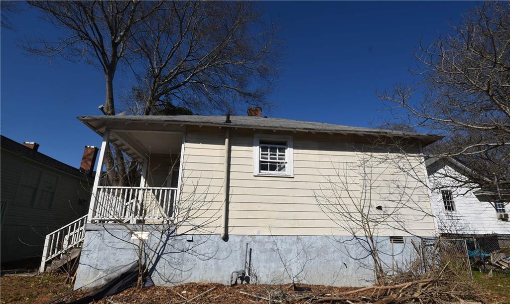 68 Poplar Street Porterdale, GA 30014 - Photo 5 of 13 a backyard of a house with table and chairs