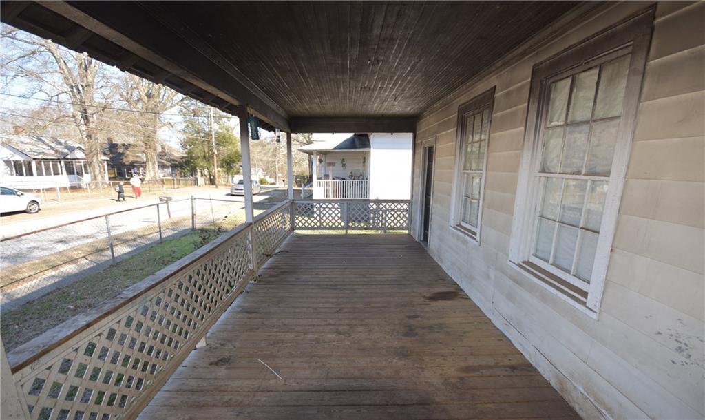 68 Poplar Street Porterdale, GA 30014 - Photo 6 of 13 a view of a porch with wooden floor and outdoor space