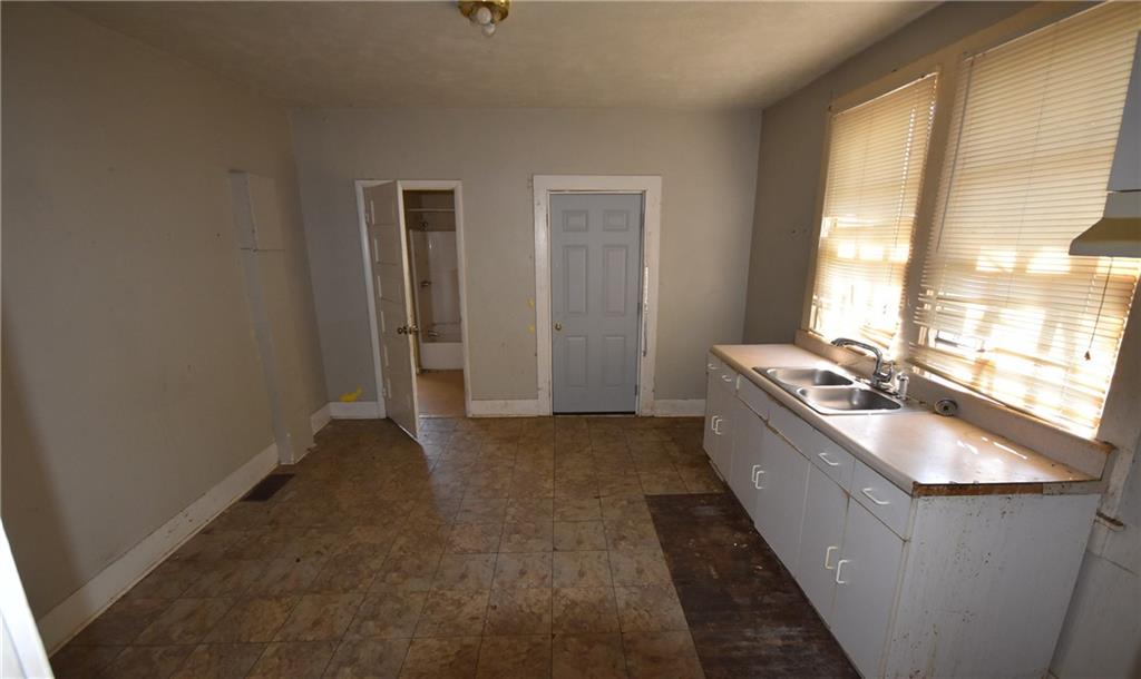 68 Poplar Street Porterdale, GA 30014 - Photo 8 of 13 a kitchen with stainless steel appliances granite countertop a sink stove and refrigerator