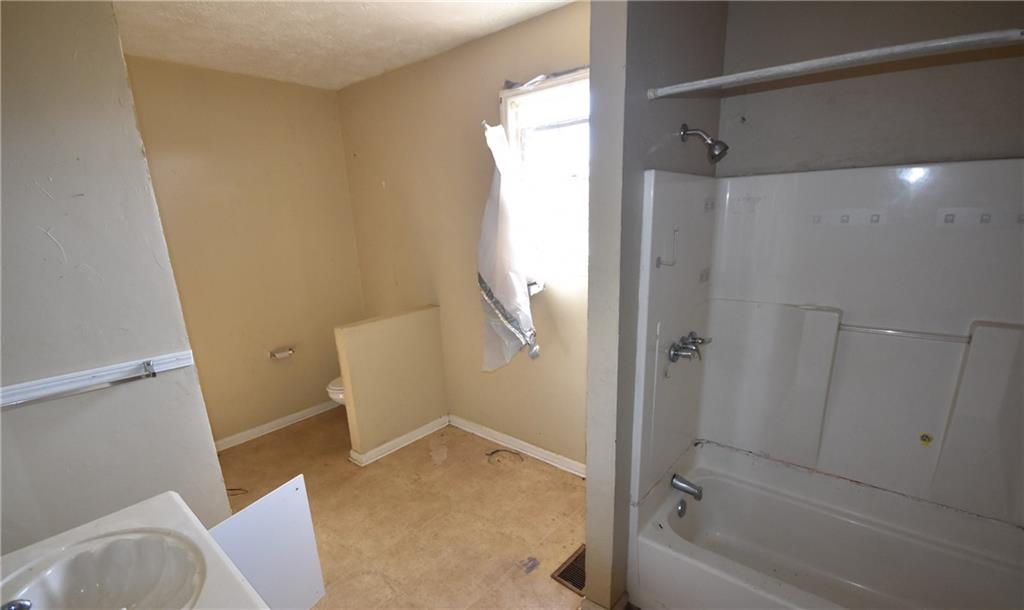 68 Poplar Street Porterdale, GA 30014 - Photo 9 of 13 a bathroom with a tub and sink