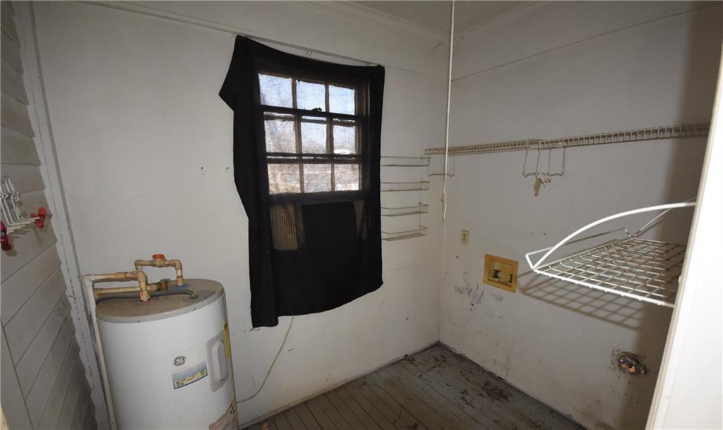 68 Poplar Street Porterdale, GA 30014 - Photo 10 of 13 a storage room with wooden floor washer and dryer