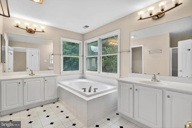 a white bath tub sitting next to a bathroom sink