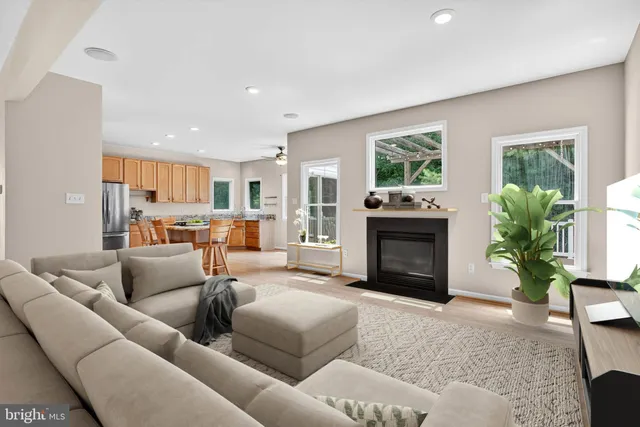a living room with furniture a fireplace and a window