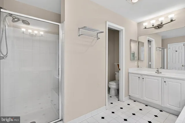 a spacious bathroom with a shower and a sink