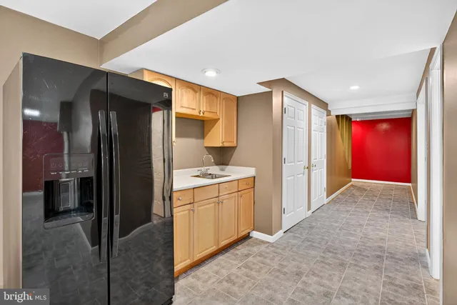 a kitchen with stainless steel appliances granite countertop a refrigerator and a stove