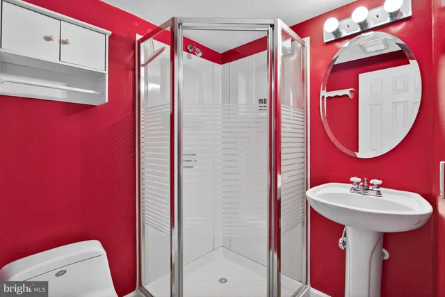 a bathroom with a sink mirror and toilet