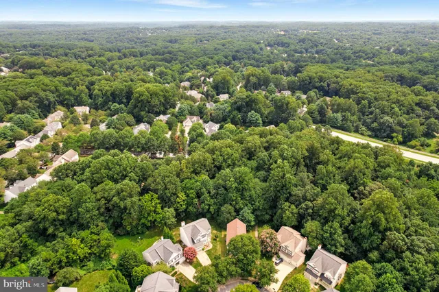 an aerial view of a houses with a yard