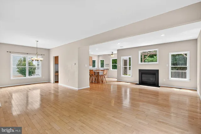 a view of an empty room with window and fire place