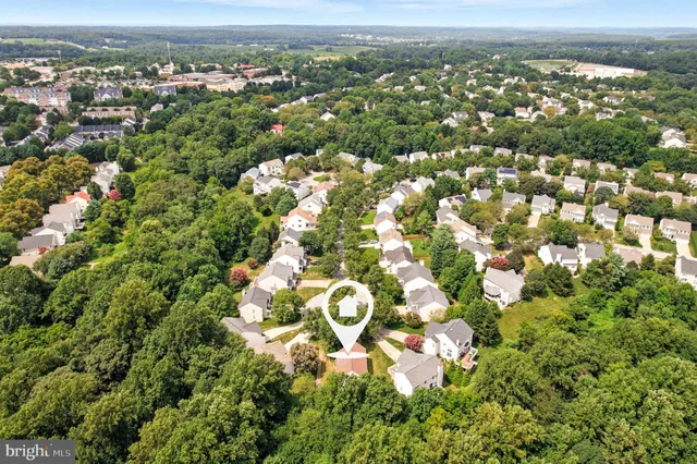 an aerial view of a residential houses with city view