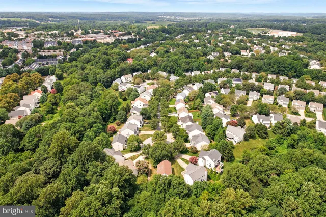 an aerial view of a residential houses with city view