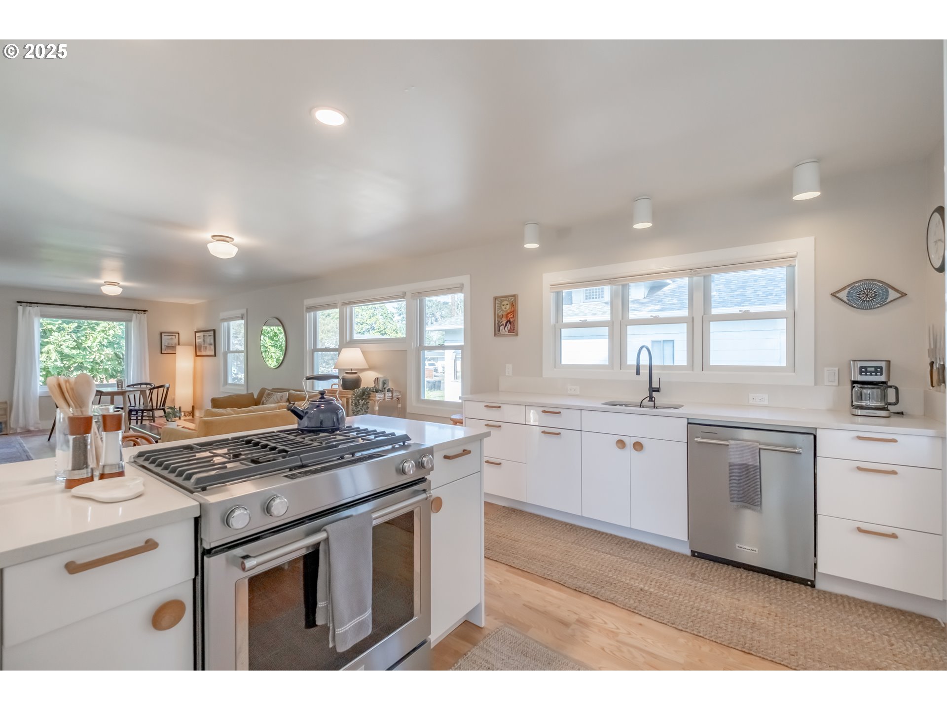 206 East 5th Street Newberg, OR 97132 - Photo 16 of 48 a kitchen with stainless steel appliances granite countertop a stove sink and cabinets