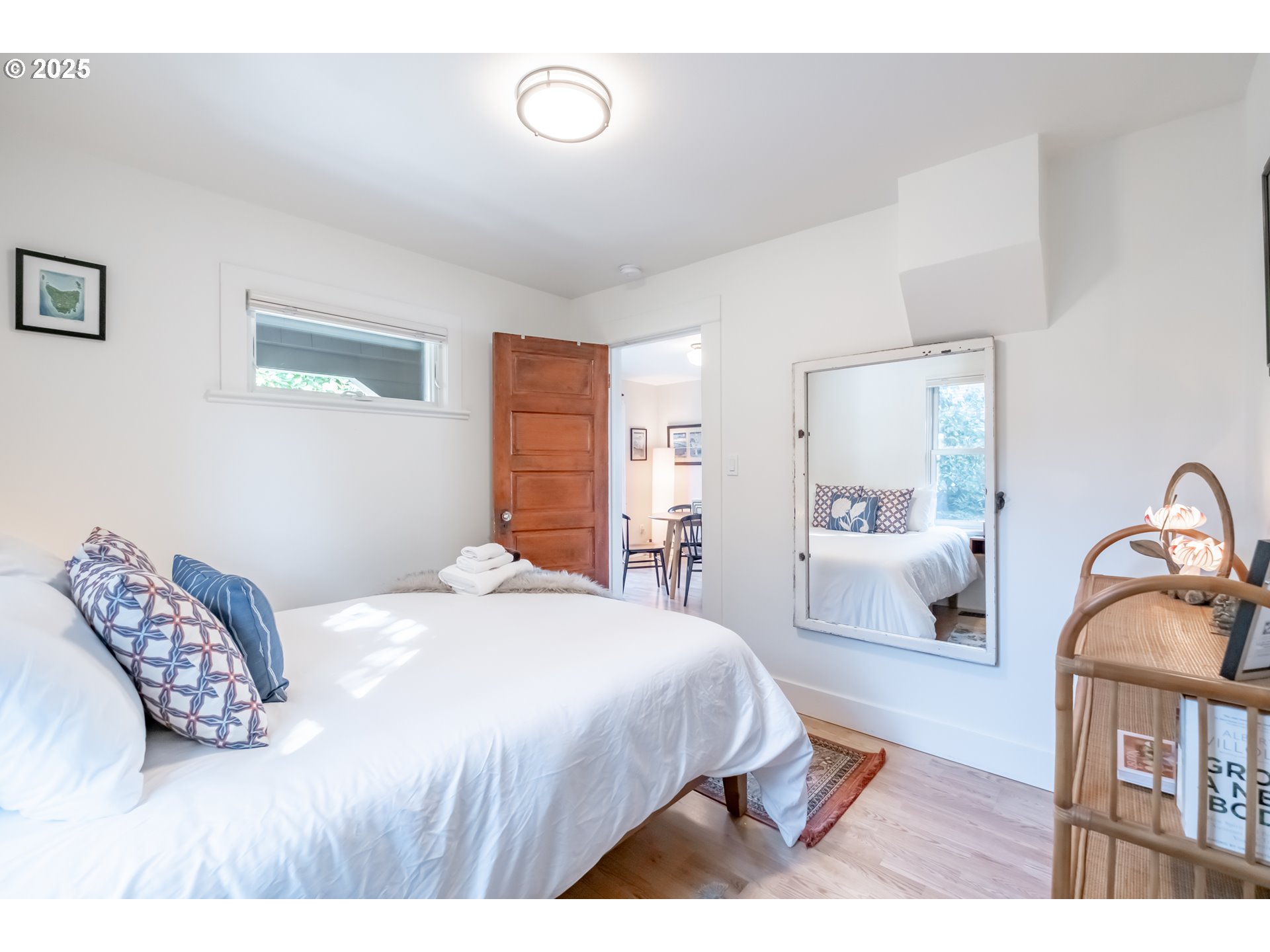 206 East 5th Street Newberg, OR 97132 - Photo 26 of 48 a bedroom with a bed and wooden floor