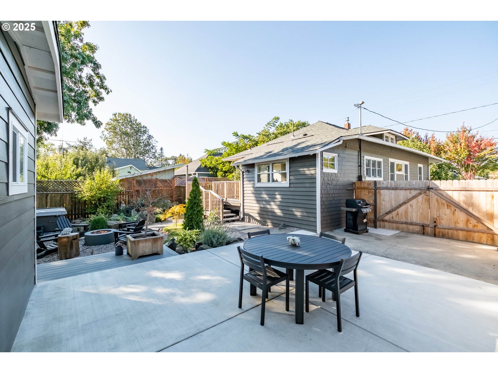 206 East 5th Street Newberg, OR 97132 - Photo 37 of 48 a backyard of a house with table and chairs