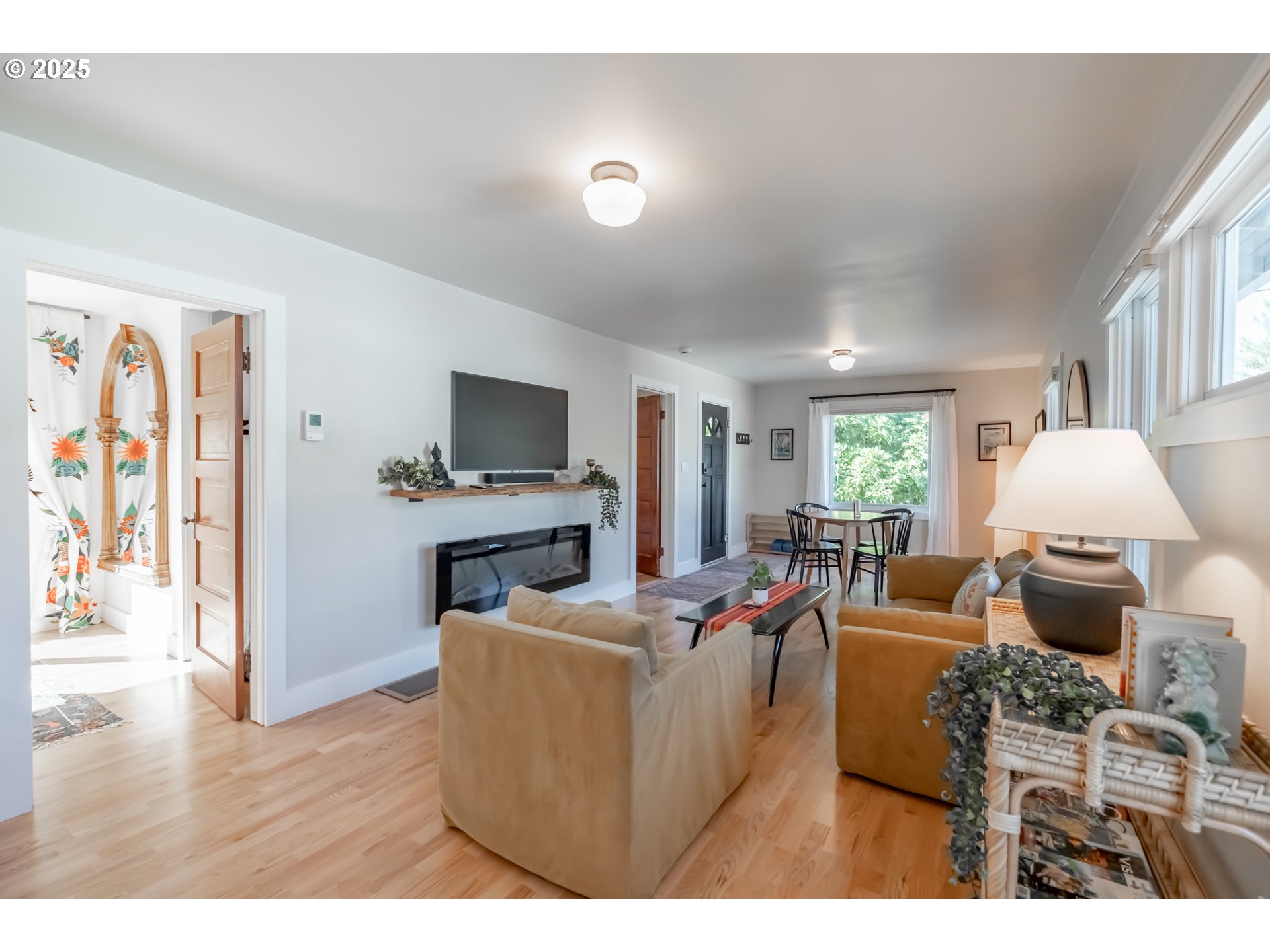 206 East 5th Street Newberg, OR 97132 - Photo 10 of 48 a living room with furniture a fireplace and a flat screen tv