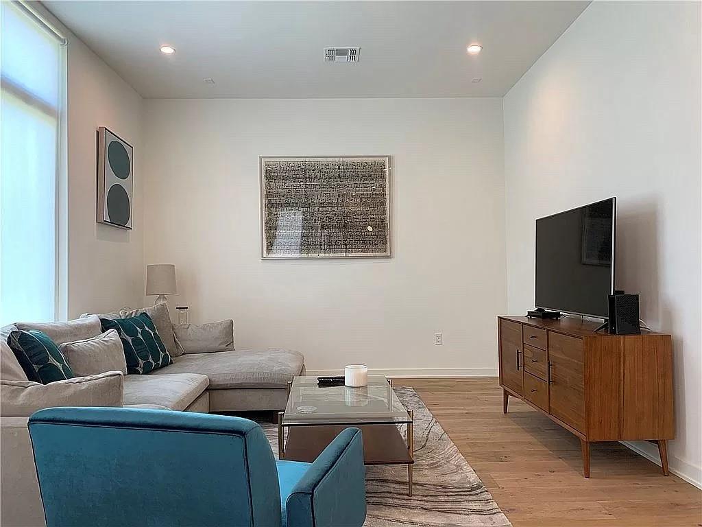 2519 Sutherland Street Austin, TX 78746 - Photo 4 of 14 a living room with furniture and a flat screen tv