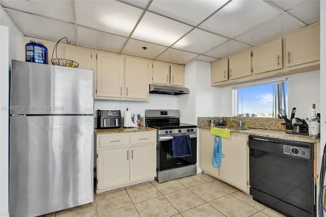 a view of a kitchen with a refrigerator and a stove
