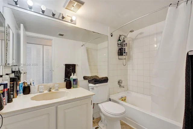 a bedroom with a bed and a view of balcony