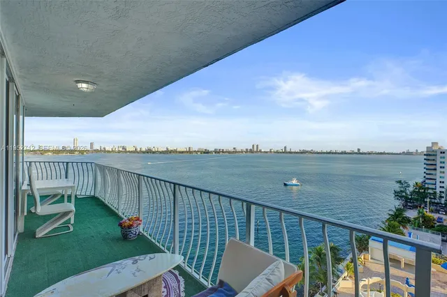 a view of a balcony with lake view and wooden fence