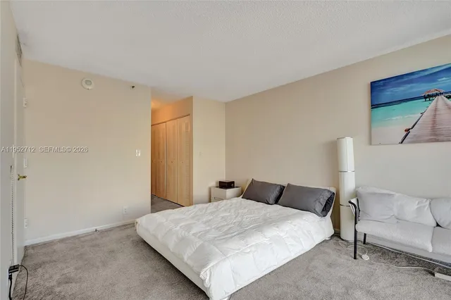 a bathroom with a sink a toilet a mirror and shower curtain