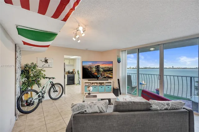 a living room with furniture and a floor to ceiling window