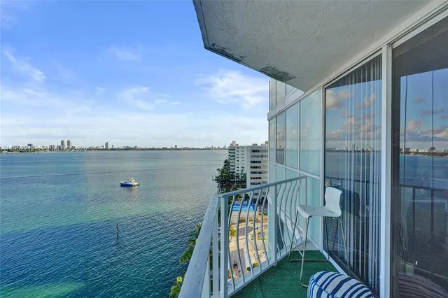 a view of a balcony with wooden floor and lake view