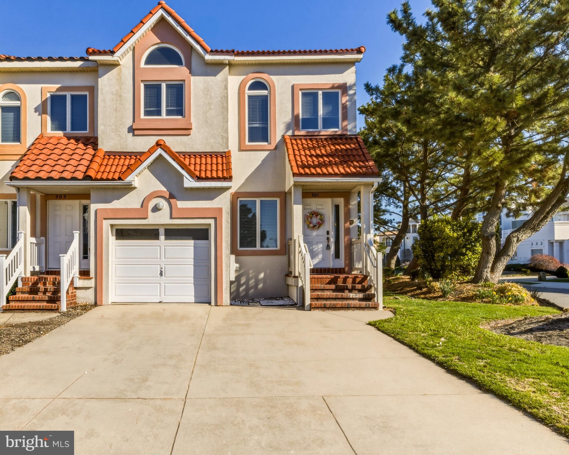 301 Gull Cove Brigantine, NJ 08203 - Photo 1 of 40 a front view of a house with a yard
