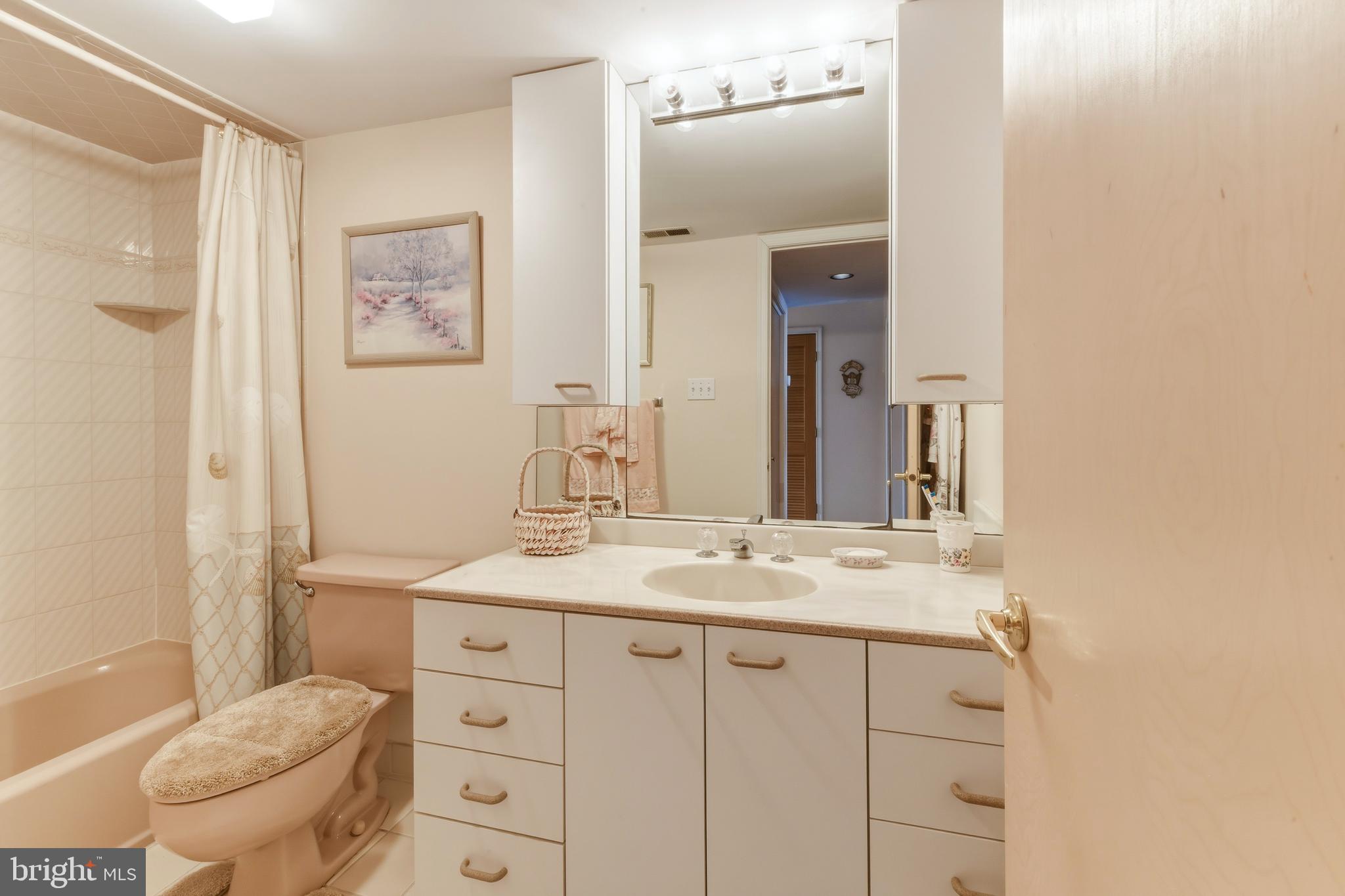 301 Gull Cove Brigantine, NJ 08203 - Photo 11 of 40 a bathroom with a granite countertop sink vanity mirror and toilet