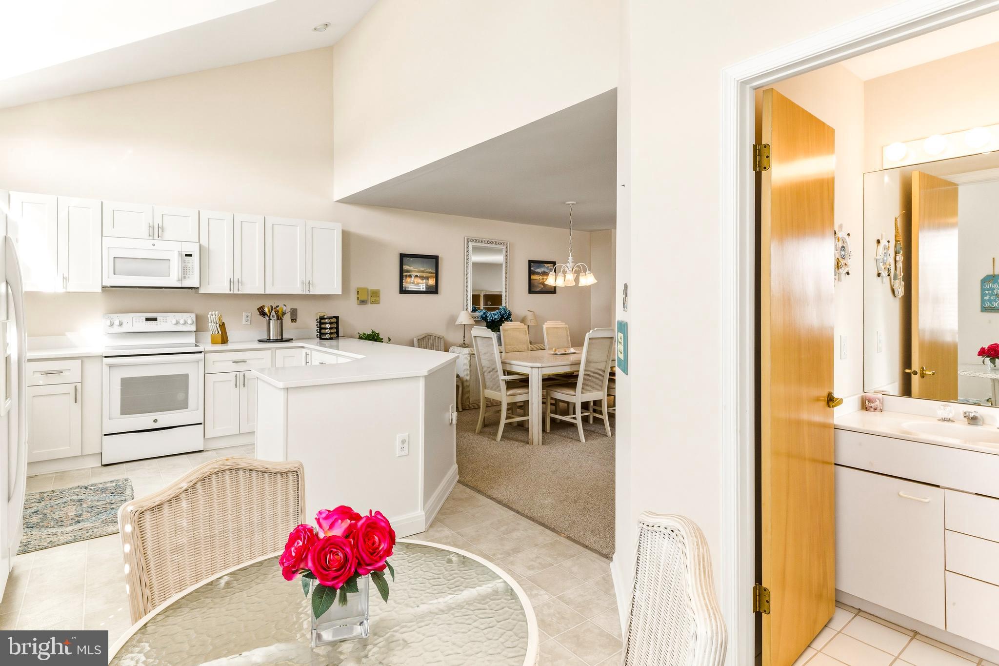 301 Gull Cove Brigantine, NJ 08203 - Photo 16 of 40 a kitchen with a sink stove and white cabinets