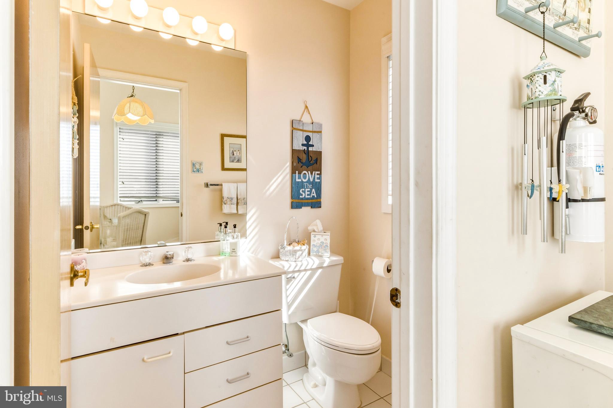 301 Gull Cove Brigantine, NJ 08203 - Photo 17 of 40 a bathroom with a sink a toilet and a mirror