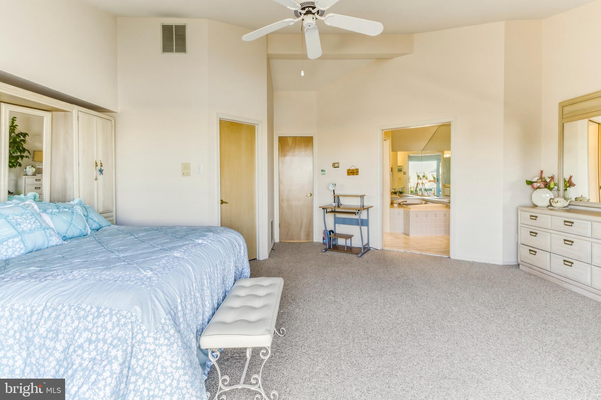301 Gull Cove Brigantine, NJ 08203 - Photo 29 of 40 a bedroom with a bed and a chandelier