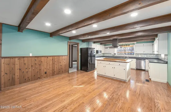 a large kitchen with stainless steel appliances granite countertop a large counter top and a stove