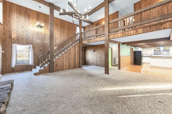 a view of a hallway with a large dining table